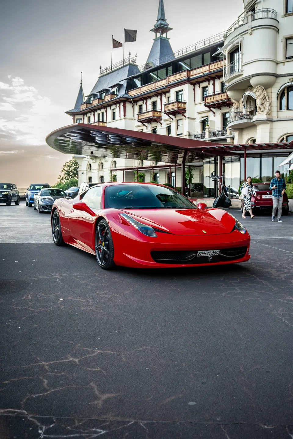 Ferrari 458 Italia arriving at a lakeside luxury hotel