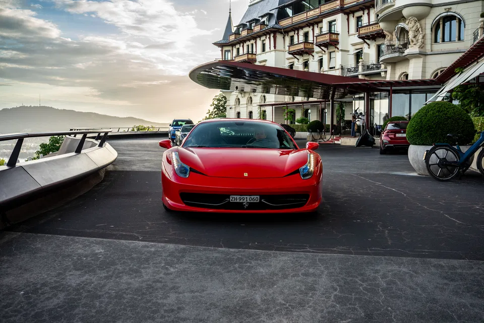 Ferrari 458 Italia at the hotel entrance overlooking the lake