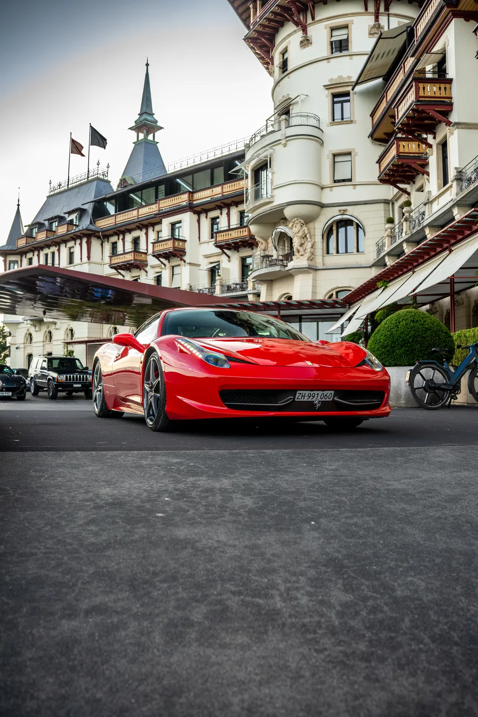 Ferrari 458 Italia in front of a grand historic hotel