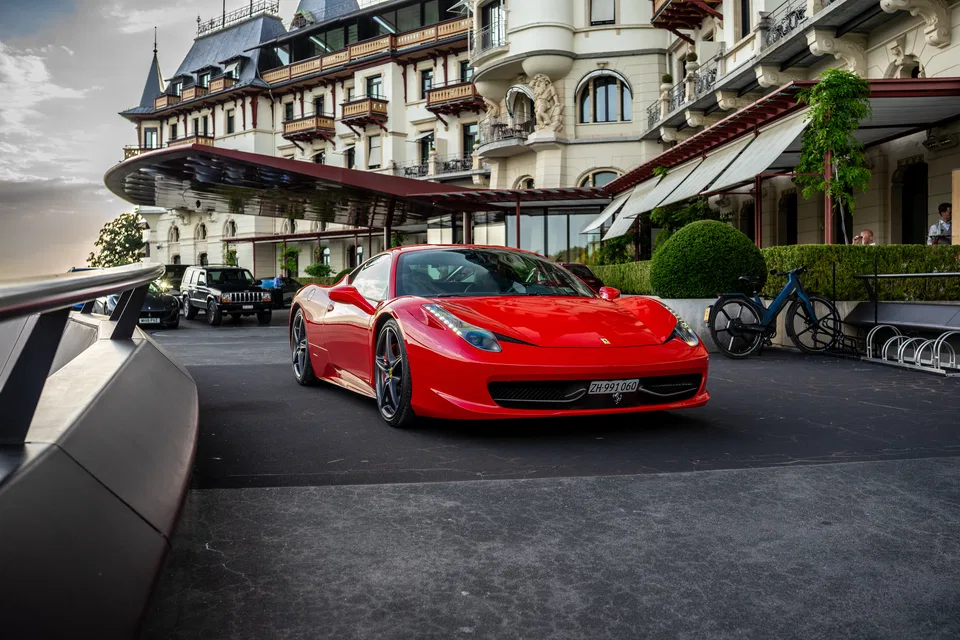 Ferrari 458 Italia on the terrace of a lakeside luxury hotel