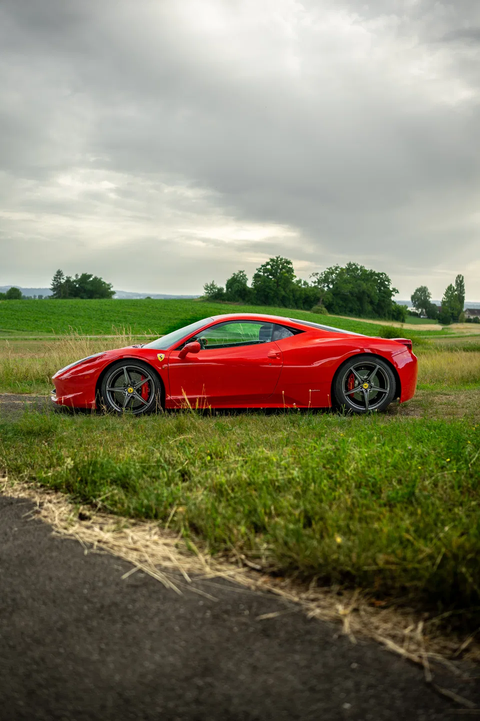 Ferrari 458 Italia side profile beside open fields